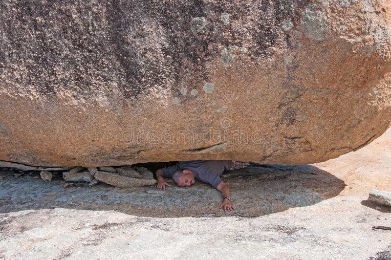 man-crushed-under-rock-gigantic-boulder-49435784.jpg