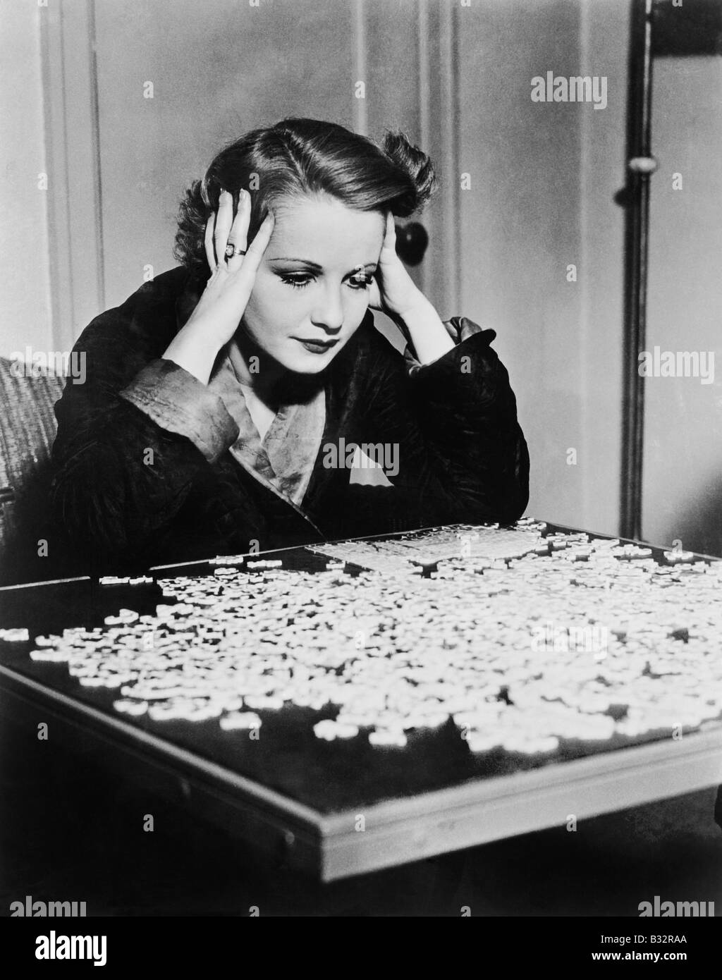 young-woman-trying-to-solve-a-puzzle-B32RAA.jpg