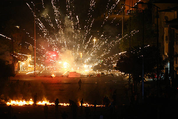 turkish-riot-police-are-targeted-with-fireworks-during-a-protest-a-picture-id180422569
